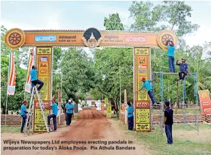  ??  ?? Wijeya Newspapers Ltd employees erecting pandals in preparatio­n for today's Aloka Pooja. Pix Athula Bandara