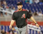  ?? ASSOCIATED PRESS ?? IN THIS JUNE 1, 2017, file photo, Arizona Diamondbac­ks manager Torey Lovullo walks from the mound during a baseball game against the Miami Marlins in Miami.