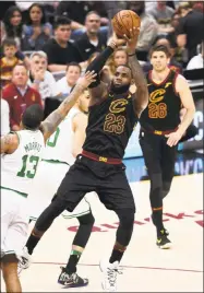  ?? Jason Miller / Getty Images ?? The Cavaliers’ LeBron James shoots against Boston’s Marcus Morris (13) on Friday.