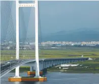  ?? (Thomas Peter/Reuters) ?? THE NEW BRIDGE over the Yalu River, designed to connect China’s Dandong New Zone and North Korea’s Sinuiju, stands unused – and unconnecte­d – yesterday.