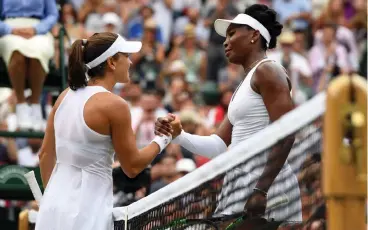  ?? Picture: GERRY PENNY, EPA ?? WELL PLAYED: Venus Williams at the net with Alexandra Dulgheru whom she beat in their second-round match at Wimbledon yesterday.