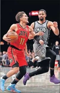  ??  ?? Atlanta Hawks guard Trae Young (11) drives to the basket against Brooklyn Nets guard Spencer Dinwiddie (8) during Saturday's game. Young and the Hawks will be playing a home game in Atlanta on Friday night before OU's playoff on Saturday in Atlanta. [AP PHOTO/NOAH K. MURRAY]