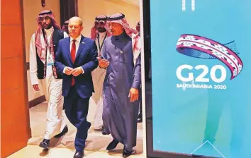  ?? Reuters ?? German Finance Minister Olaf Scholz and Saudi Minister of Finance Mohammad Al Jadaan walk to the G20 finance ministers and central bank governors meeting in Riyadh yesterday.