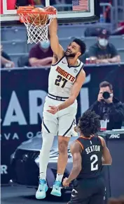  ?? AP ?? Jamal Murray (left) of Denver Nuggets dunks next to Collin Sexton of Cleveland Cavaliers during their NBA game in Cleveland on Friday. —