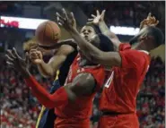  ?? BRAD TOLLEFSON — THE ASSOCIATED PRESS ?? West Virginia’s Sagaba Konate (50), Texas Tech’s Norense Odiase (32) and Niem Stevenson (10) go for a rebound during the second half Jan. 13 in Lubbock, Texas.