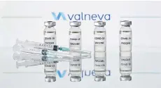  ?? — AFP photo ?? Photo shows vials with Covid-19 Vaccine stickers attached and syringes with the logo of French-Austrian vaccine firm Valneva.
