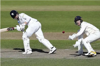  ?? Martin Rickett ?? Derbyshire’s Harvey Hosein hits out past Lancashire wicket keeper Alex Davies, during the pre-season match at Emirates Old Trafford, on Monday