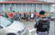  ?? AFP ?? A police officer stands guard outside the police station where the perpetrato­r of two school shootings is being held in Aracruz, Espirito Santo State, Brazil, on Friday.