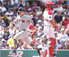  ?? (AP photo/michael Dwyer) ?? Cleveland Guardians’ Will Brennan scores on an RBI double by Gabriel Arias behind Boston Red Sox catcher Reese Mcguire on Monday during a baseball game in Boston.