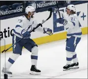  ?? JAY LAPRETE — THE ASSOCIATED PRESS ?? Tampa Bay’s Brayden Point, right, celebrates his overtime goal with Victor Hedman as the Lightning beat the Columbus Blue Jackets on Thursday.