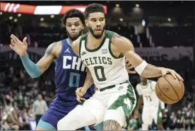  ?? AP photo ?? Charlotte Hornets forward Miles Bridges guards against Boston Celtics forward Jayson Tatum during the first half in Charlotte, N.C., on Monday.