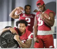  ?? NWA Democrat-Gazette/CHARLIE KAIJO ?? Devwah Whaley (bottom left), Chase Hayden (top left) and T.J. Hammonds are among the returning running backs for the Arkansas Razorbacks. Whaley, who started 12 games last season, is the Razorbacks’ leading returning rusher with 559 yards and 7 touchdowns.