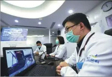  ?? LONG WEI / FOR CHINA DAILY ?? Chinese doctors provide free consulting service to Chinese and foreign patients through WeDoctor’s online platform in Hangzhou, capital of Zhejiang province, on March 17.