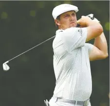  ?? GETTY IMAGES ?? Bryson Dechambeau drives from the 11th tee during the first round of play at the Rocket Mortgage Classic on Thursday. The American delivered a blistering back nine in carding a 6-under 66 for the day.