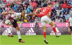  ??  ?? MUNICH: Ingolstadt’s Congolese midfielder Marcel Tisserand and Bayern Munich’s Polish striker Robert Lewandowsk­i vie for the ball during the German first division Bundesliga football match of Bayern Munich vs FC Ingolstadt in Munich, southern Germany,...