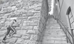  ?? AFP ?? A young boy climbs a wall near the stairs made famous by 'The Exorcist' in Georgetown in Washington. —