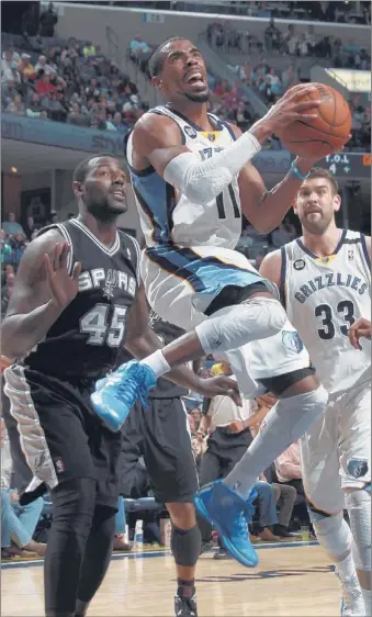  ?? NIKKI BOERTMAN/ THE COMMERCIAL APPEAL ?? Grizzlies guard Mike Conley slips past San Antonio’s DeJuan Blair during Monday’s game in FedExForum. Conley also shot the game-winner for the Grizzlies with 0.6 seconds left in the game.