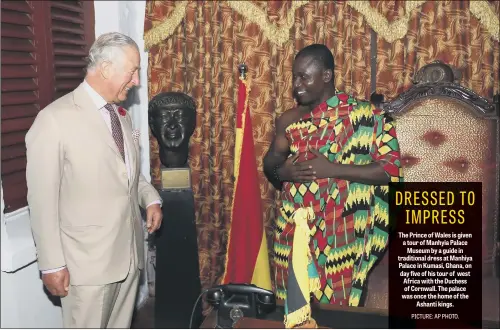  ??  ?? The Prince of Wales is given a tour of Manhyia Palace Museum by a guide in traditiona­l dress at Manhiya Palace in Kumasi, Ghana, on day five of his tour of west Africa with the Duchess of Cornwall. The palace was once the home of the Ashanti kings.