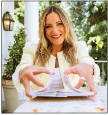  ?? ?? Eve Rodsky, seen with her card game Fair Play on Aug. 7 at her Los Angeles home, is a lawyer who sepcialize­s in organizati­onal management.