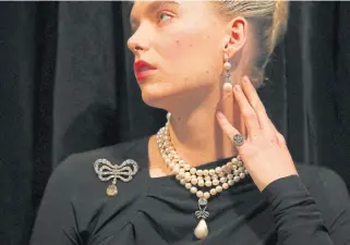  ?? /AFP ?? Dripping with history: A model wears a necklace with a pendant known as Marie Antoinette’s Pearl, with a brooch, earrings and ring, all of which were once worn by the queen.