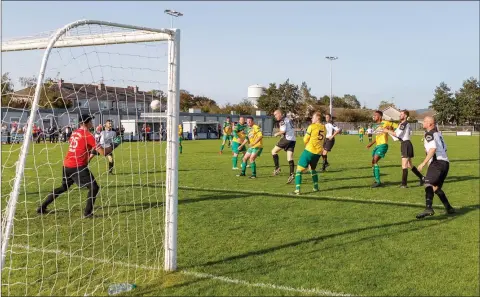  ??  ?? Darren Lacey with a bullet header to the back of the Ratnnew net for St Peter’s during the Wicklow Cup final.