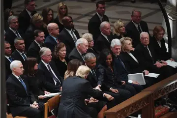  ??  ?? President Donald Trump and first lady Melania Trump greet former President Barack Obama and Michelle Obama at the state funeral for former President George H.W. Bush at the National Cathedral. — Washington Post photo by Matt McClain