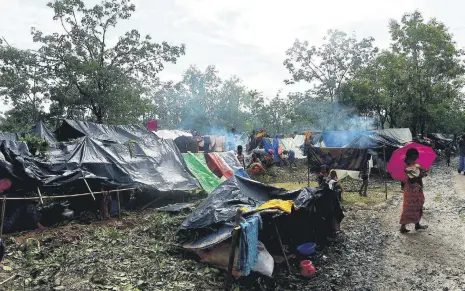  ??  ?? Rohingya refugees gather by newly built shelters at Kutupalong refugee camp in Bangladesh's Ukhiya district on Sept. 9.