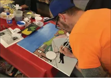  ?? ANDREW CASS — THE NEWS-HERALD ?? Artist Colin Gonzalez works on his painting Nov. 17at Garage Bar in Willoughby as part of a collaborat­ive art project that will be turned into a mural.