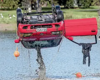  ?? PHOTO: IAIN MCGREGOR/STUFF ?? The bodies were found close to the car which was pulled from a lake in Halswell, Christchur­ch, on Wednesday afternoon.