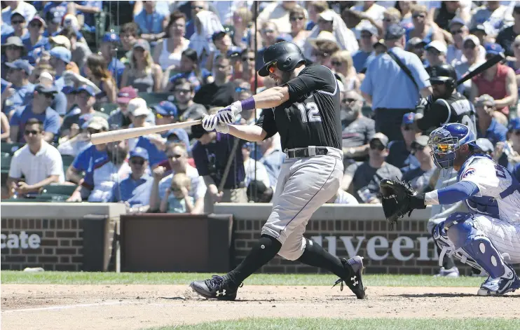  ?? — GETTY IMAGES ?? Mark Reynolds of the Rockies homers against the Cubs on Saturday at Wrigley Field. Colorado won 9-1 as Chicago’s losing skid hit four games.