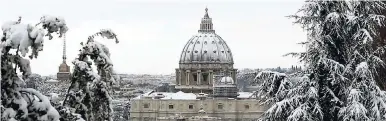  ?? AP ?? A view of a snow-capped St. Peter’s Dome after a snowfall, in Rome yesterday