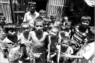  ??  ?? Muslim children playing in Da Paing IDP camp near Sittwe.