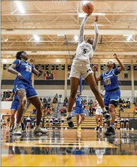  ?? DANIEL VARNADO FOR THE AJC ?? Marietta’s Makayah Harris makes a basket during Friday’s Class 7A state semifinal victory, while Jillian Hollingshe­ad (left) and Denim Deshields defend for visiting Mceachern. Marietta is trying for its first girls championsh­ip since 1951, while three other girls finalists are seeking their first titles.