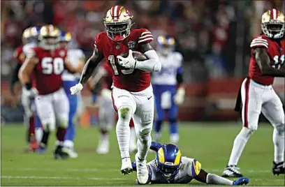  ?? JED JACOBSOHN / AP ?? 49ers wide receiver Deebo Samuel (19) runs past Rams safety Jordan Fuller to score during the second half of Monday’s game in Santa Clara.