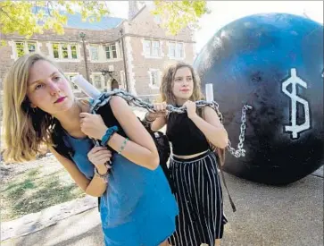  ?? Paul J. Richards AFP/Getty Images ?? WITH NATIONAL student loan debt topping $1 trillion, California lawmakers have focused on a breadth of ideas for tackling college affordabil­ity. Above, students demonstrat­e at Washington University in St. Louis.