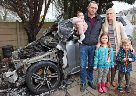  ??  ?? Narrow escape: Miles Freeman and Tanya Krupenko with children Savannah, Olivia and Harrison by the burnt-out Volvo