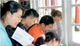  ??  ?? Tourists: Chinese visitors at a post office in Colombo