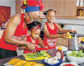  ??  ?? HEALTHY ROLE MODEL: Khaya Kepe cooks with her children Shulami, three, and Zion, six, teaching them about a healthy diet and having fun in the process