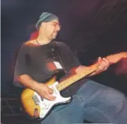  ??  ?? Pat DiNizio, the frontman of the Smithereen­s, jams at the LoDo Music Festival.