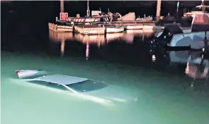  ?? ?? The submerged car after onlookers were able to pull the 70-year-old driver to safety