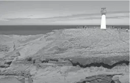  ?? ?? The Cap-Herisse Lighthouse on one of the Magdalen islands in Canada's Gulf of St. Lawrence. The island was one of the stops on a 10-day cruise through New England and eastern Canada.