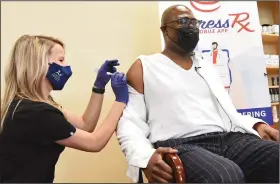  ?? (Arkansas Democrat-Gazette/Staci Vandagriff) ?? Whitney Campbell, a pharmacist for Express Rx, gives Little Rock Mayor Frank Scott Jr. a dose of the Johnson & Johnson covid-19 vaccine Wednesday at the Express Rx at Otter Creek in Little Rock.