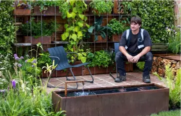  ?? Pic: Neil Hepworth/RHS/PA ?? Conal McGuire in his award-winning ‘Brickyard’ garden at RHS Flower Show Tatton Park in 2023