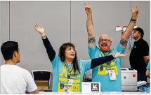  ??  ?? Elizabeth Trujillo (left) and Kelly Alexander offer help to guests arriving for early SXSW badge pickup at the Austin Convention Center.