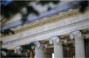  ?? AP PHOTO/PATRICK SEMANSKY ?? This June 6, 2019, file photo shows the U.S. Treasury Department building at dusk in Washington. On Monday the Treasury Department said it expects to borrow $463 billion in the current April-June quarter and $2.28 trillion for the full budget year, as the government finances continued pandemic relief measures.