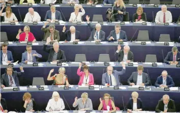  ?? — Reuters ?? Members of the European Parliament take part in a vote on a resolution on the jailing of Reuters journalist­s in Myanmar, during a voting session at the European Parliament in Strasbourg, France, on Thursday.