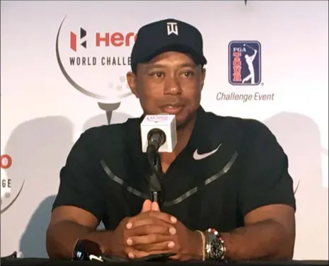  ?? AP PHOTO ?? Tiger Woods speaks at a press conference at the Albany Golf Club in Nassau, Bahamas, on Tuesday. Woods is playing in this weeks Hero World Challenge, his first tournament since fusion surgery on his lower back in April.