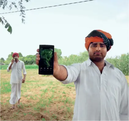  ??  ?? TRADITION VERSUS MODERNITY A farmer couple cultivates land near Udaipur in Rajasthan (far left); farmers in Rajawas village in Jaipur district