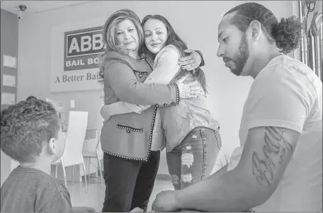  ?? Photograph­s by Irfan Khan Los Angeles Times ?? JORGE GARCIA, right, wife Claudia Abarca and 2-year-old son Jaasiel Garcia visit Redlands bail agent Jane Un, left. Un has privately reached out to lawmakers about the abuses she’s seen by bail agents. Now she’s being more vocal and calling for a...