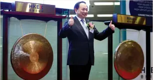  ?? (Bobby Yip/Reuters) ?? POSTAL SAVINGS BANK of China chairman Li Guohua poses during the listing of the bank, the world’s biggest initial public offering in two years, at the Hong Kong Stock Exchange yesterday.